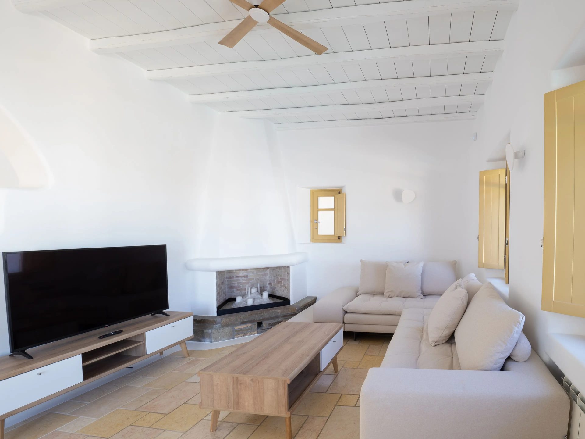 Living room with TV at Villa Gaia in Psarou, Mykonos