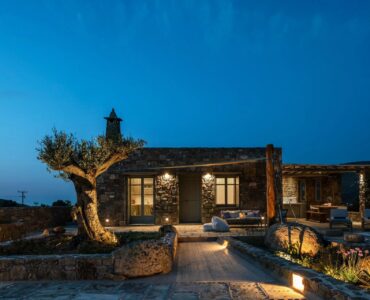 Stone villa and olive tree at night at Villa Kele in Ftelia, Mykonos