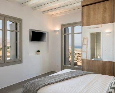 Double bedroom with sea-view window at Villa Kele in Ftelia, Mykonos