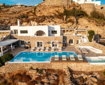 Aerial view of Villa Kymothea on the cliff in Agios Lazaros, Mykonos