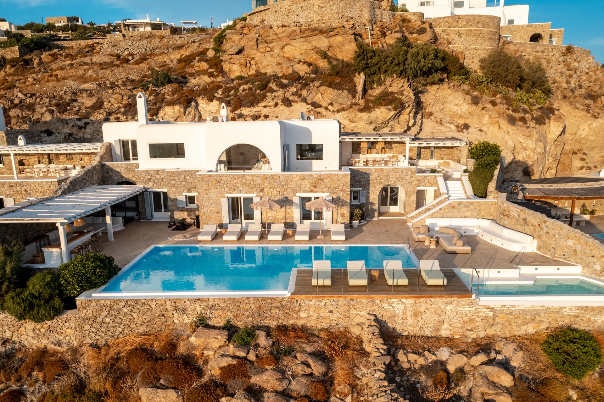 Aerial view of Villa Kymothea on the cliff in Agios Lazaros, Mykonos
