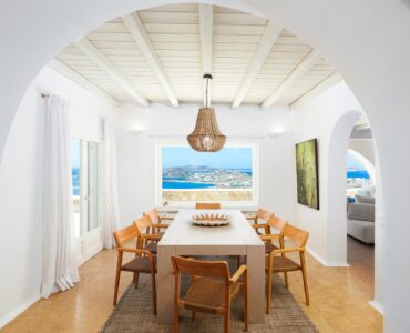 Dining room with arched window at Villa Kymothea in Agios Lazaros, Mykonos