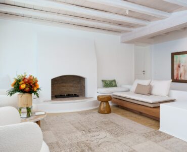 Living room with fireplace at Villa Kymothea in Agios Lazaros, Mykonos