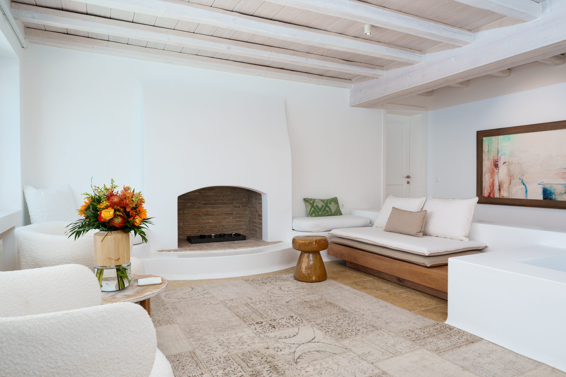 Living room with fireplace at Villa Kymothea in Agios Lazaros, Mykonos