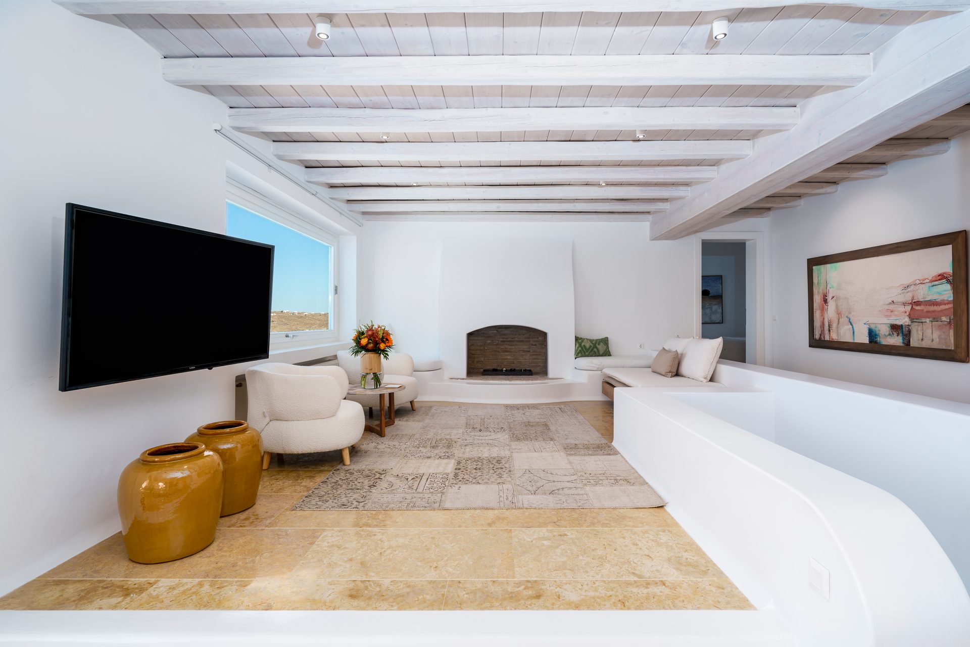 Living room with TV at Villa Kymothea in Agios Lazaros, Mykonos