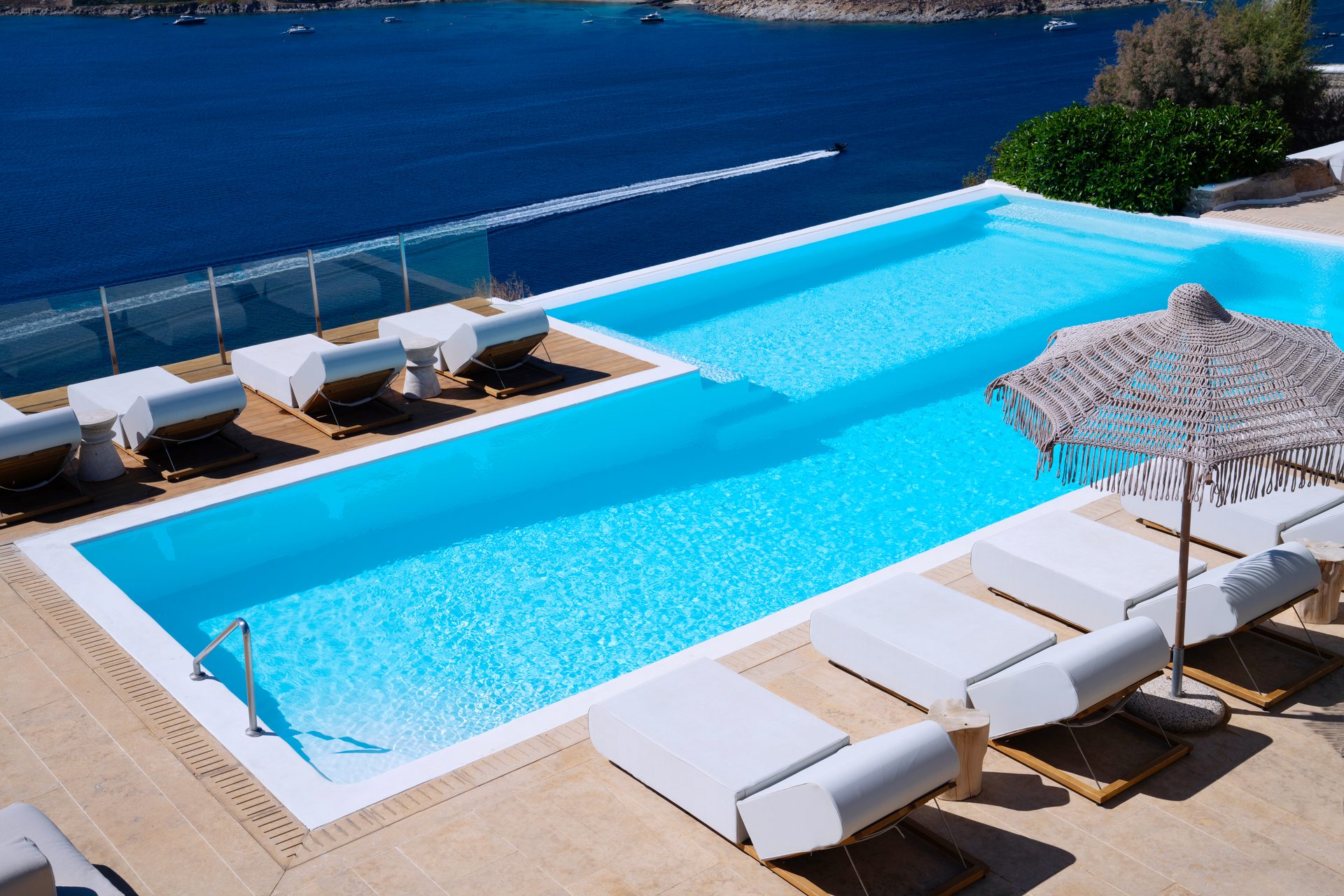 Pool with sun loungers and parasol at Villa Kymothea in Agios Lazaros, Mykonos
