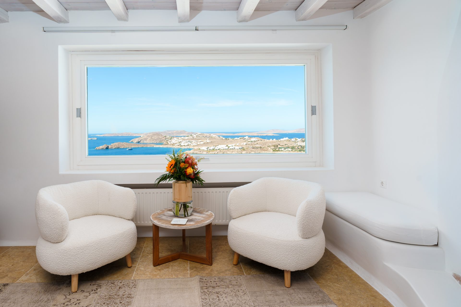 Sitting area with picture window at Villa Kymothea in Agios Lazaros, Mykonos