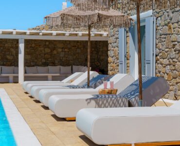 Sun loungers by the pool at Villa Kymothea in Agios Lazaros, Mykonos