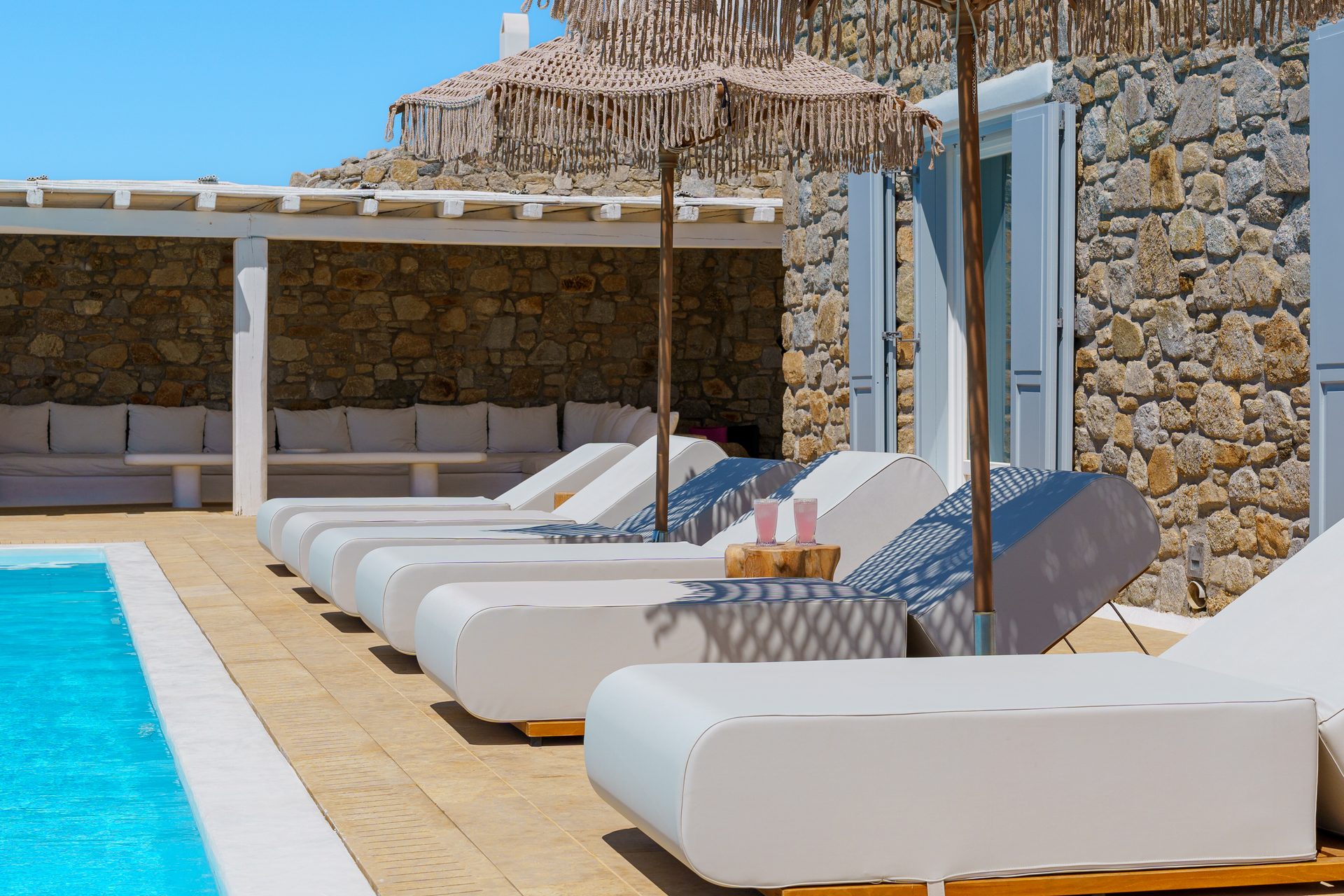 Sun loungers by the pool at Villa Kymothea in Agios Lazaros, Mykonos