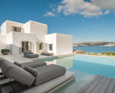 Sun loungers by the infinity pool at Villa Mare Blu in Kanalia, Mykonos