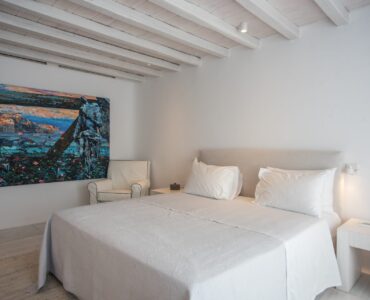 Bedroom with artwork at Villa Nafsithoi in Agios Lazaros, Mykonos