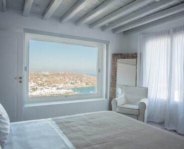 Bedroom with sea-view window at Villa Nafsithoi in Agios Lazaros, Mykonos