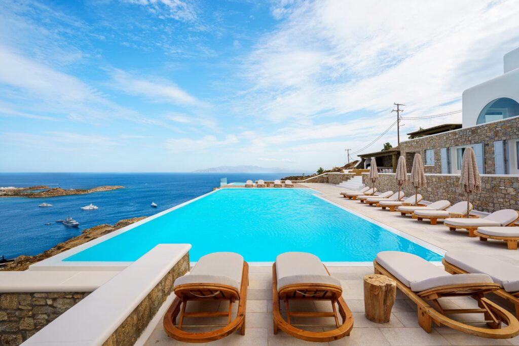 Infinity pool with sun loungers at Villa Nafsithoi in Agios Lazaros, Mykonos