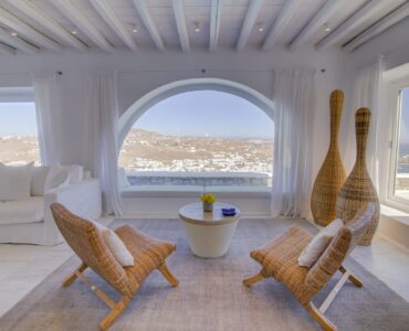 Living room with arched window at Villa Nafsithoi in Agios Lazaros, Mykonos