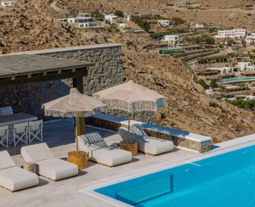 Pool deck with parasols at Villa Nafsithoi in Agios Lazaros, Mykonos