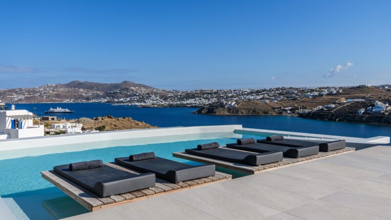 Infinity pool with in-pool sun loungers and sea view at Villa Nerovino in Kanalia, Mykonos