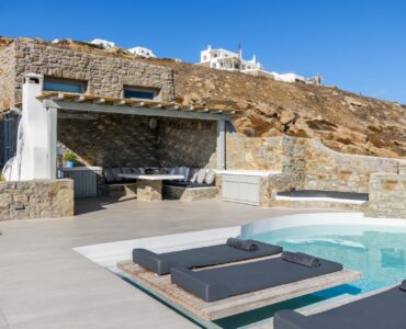 Pool terrace and covered lounge at Villa Nerovino in Kanalia, Mykonos