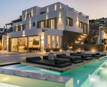 Pool lit at dusk at Villa Nerovino in Kanalia, Mykonos