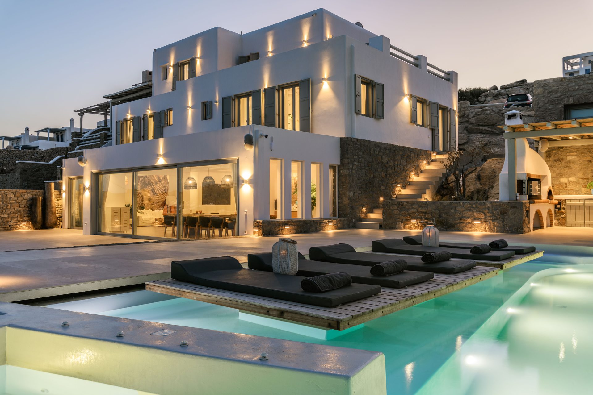 Pool lit at dusk at Villa Nerovino in Kanalia, Mykonos