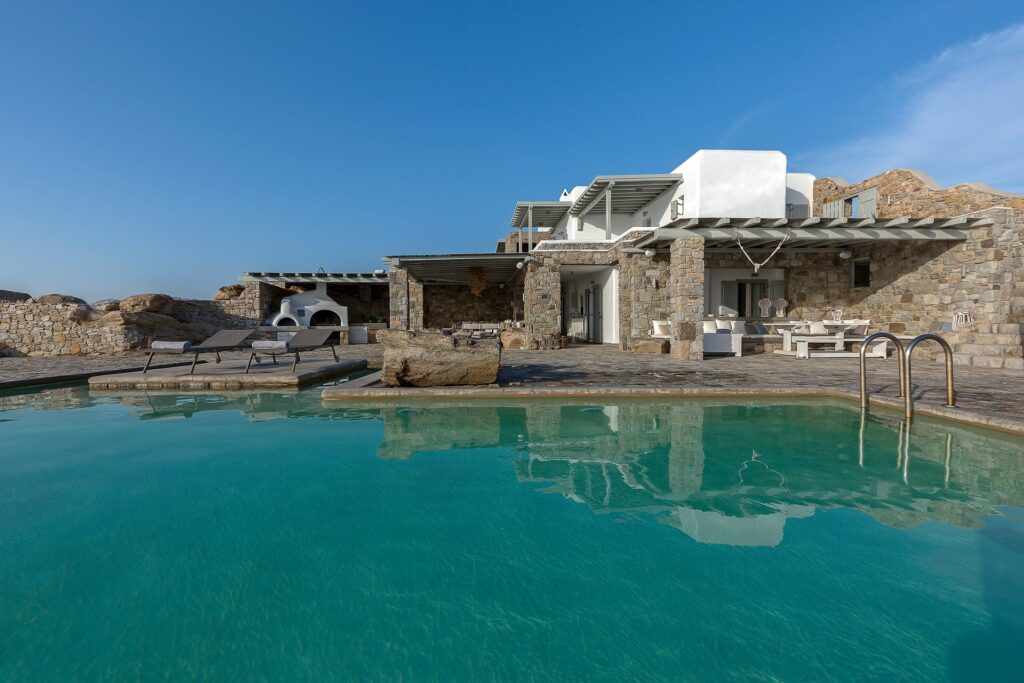 Pool and villa on the rocky coast at Villa Pergisos in Kanalia, Mykonos