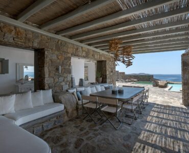 Shaded lounge with stone pillars at Villa Pergisos in Kanalia, Mykonos