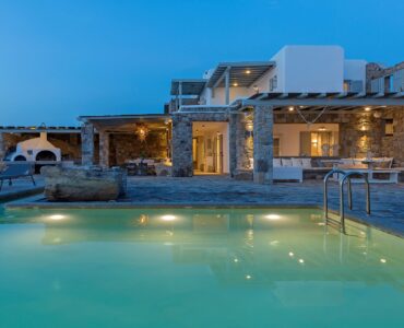 Pool lit at dusk at Villa Pergisos in Kanalia, Mykonos