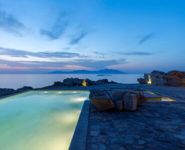 Pool at dusk with sea view at Villa Pergisos in Kanalia, Mykonos