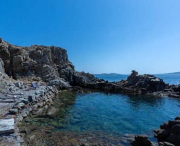 Rocky cove by the sea at Villa Pergisos in Kanalia, Mykonos