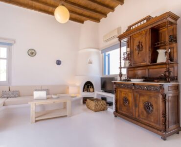 Lounge with traditional wooden cabinet at Villa Phaedra in Pouli, Mykonos