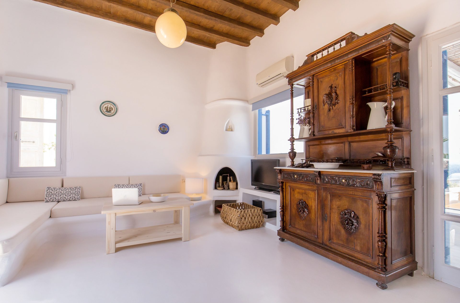 Lounge with traditional wooden cabinet at Villa Phaedra in Pouli, Mykonos