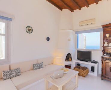Lounge with sofas and TV at Villa Phaedra in Pouli, Mykonos