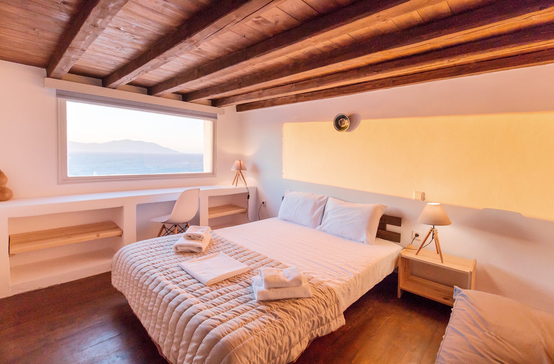Bedroom with sea-view window at Villa Phaedra in Pouli, Mykonos