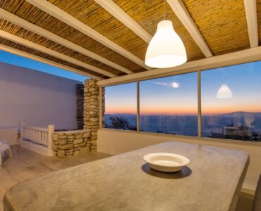 Sea-view dining room at sunset at Villa Phaedra in Pouli, Mykonos