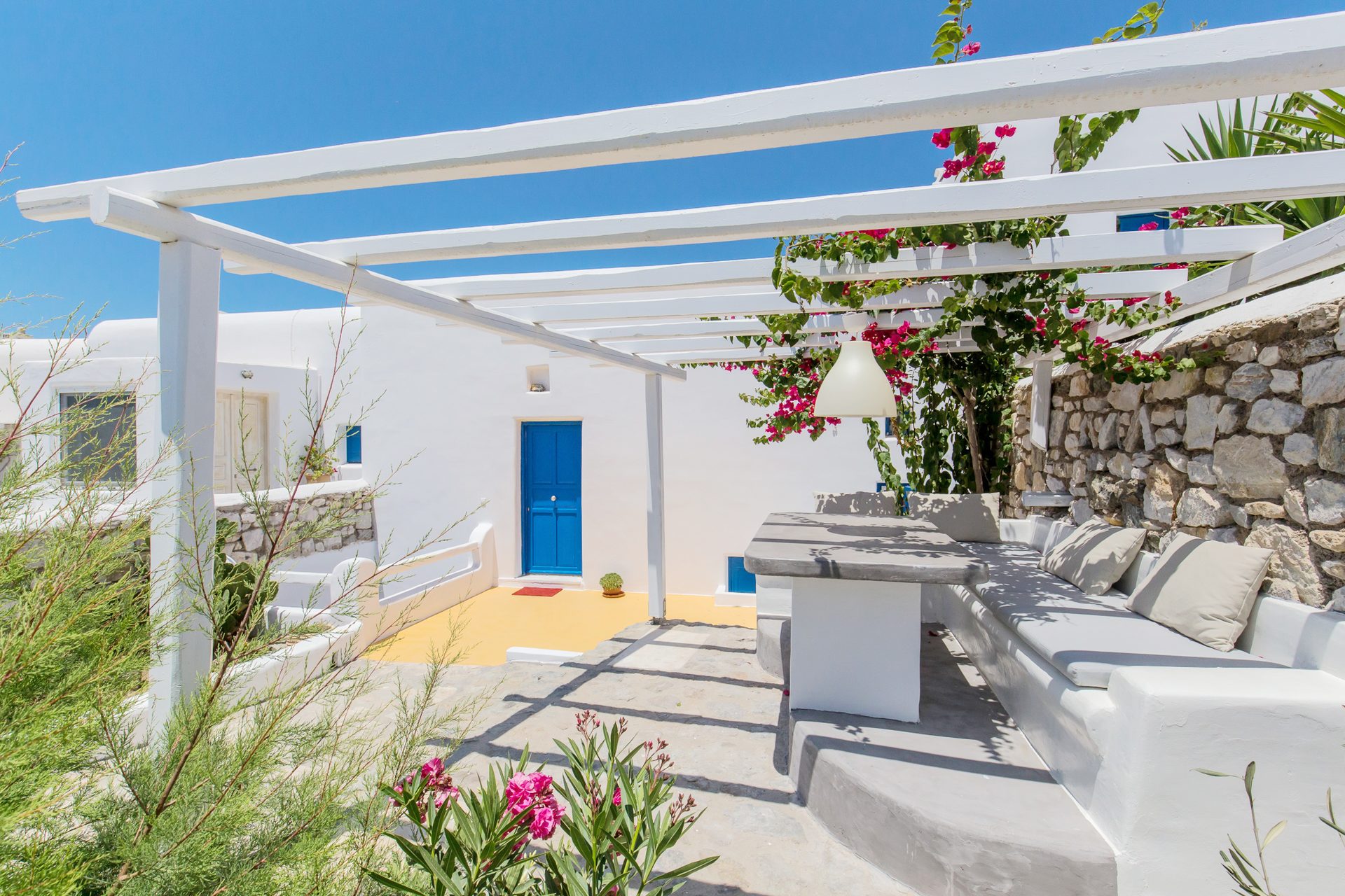 Shaded terrace with built-in seating at Villa Phaedra in Pouli, Mykonos