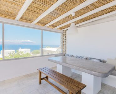 Dining room with panoramic sea view at Villa Phaedra in Pouli, Mykonos
