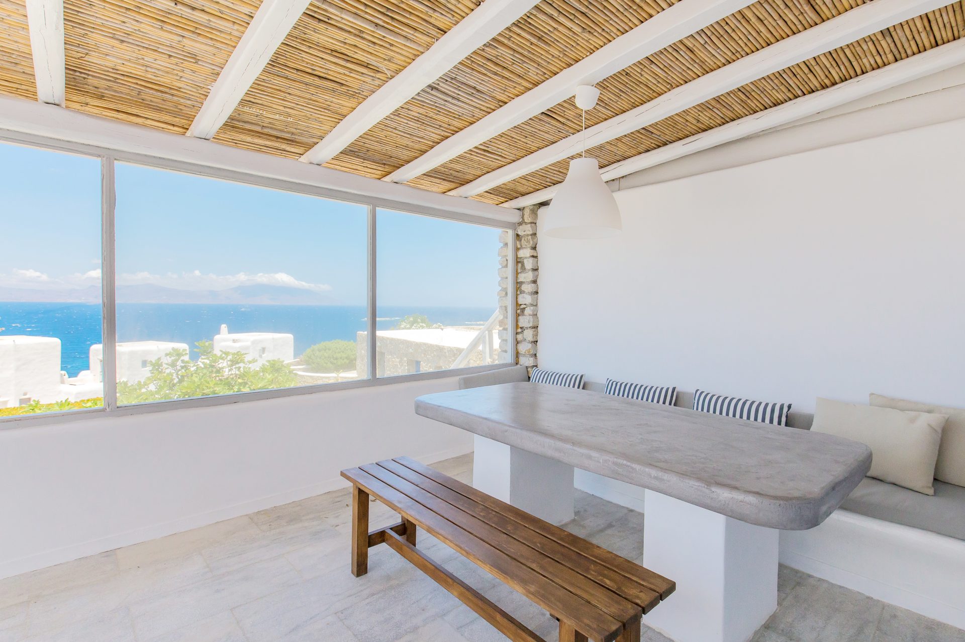 Dining room with panoramic sea view at Villa Phaedra in Pouli, Mykonos