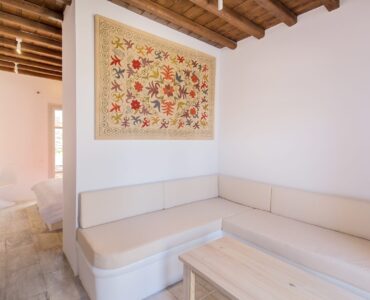Living room with built-in sofas at Villa Phaedra in Pouli, Mykonos