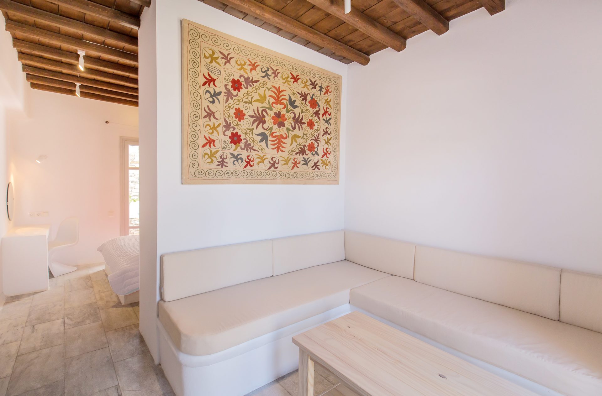 Living room with built-in sofas at Villa Phaedra in Pouli, Mykonos