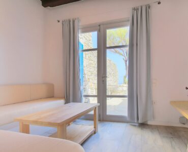 Living room with terrace doors at Villa Phaedra in Pouli, Mykonos