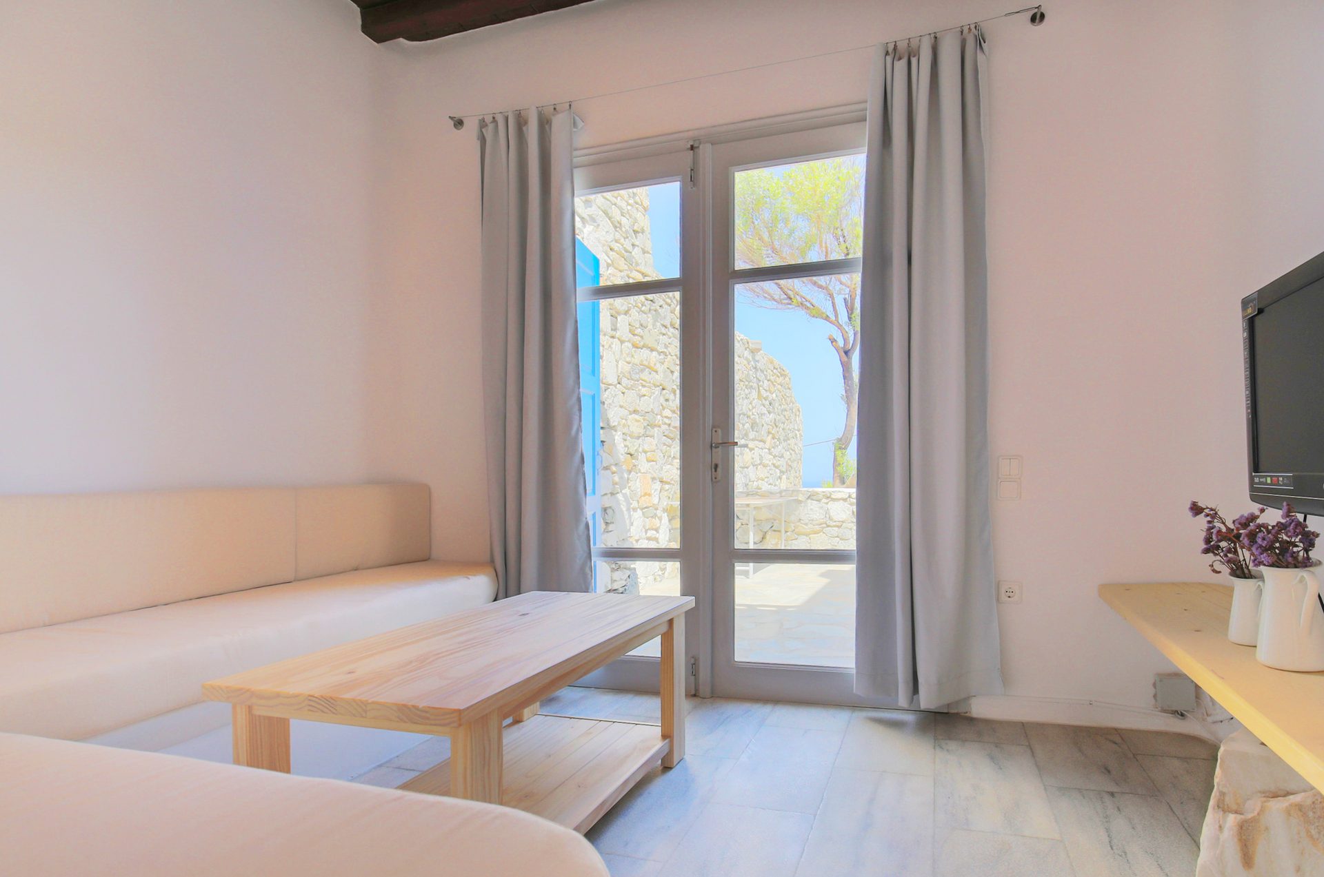 Living room with terrace doors at Villa Phaedra in Pouli, Mykonos
