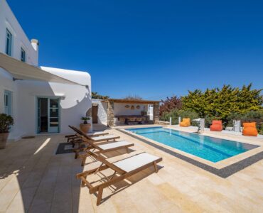 Pool with sun loungers at Villa Uranos in Psarou, Mykonos