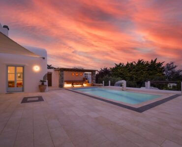 Pool terrace at sunset at Villa Uranos in Psarou, Mykonos
