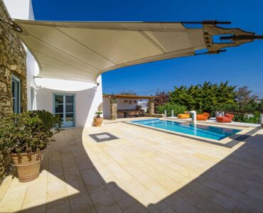 Pool seen from the shaded terrace at Villa Uranos in Psarou, Mykonos